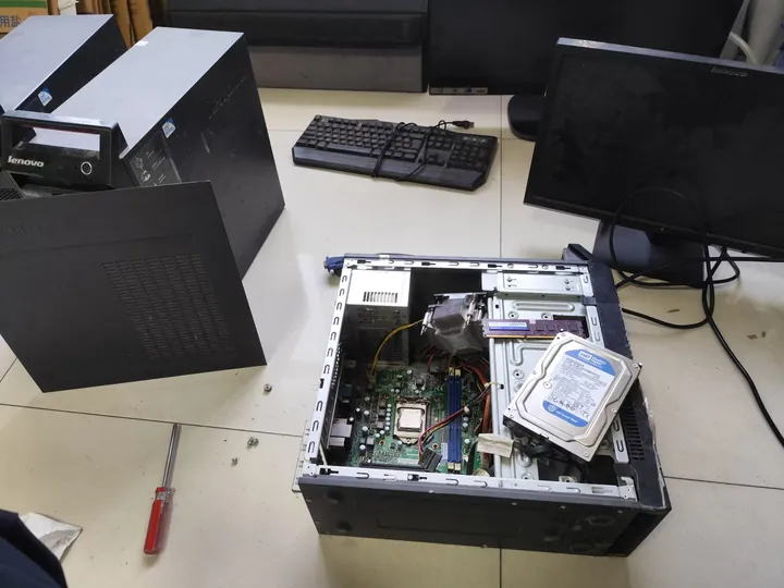 Open desktop computer inspected during IT asset recovery assessment