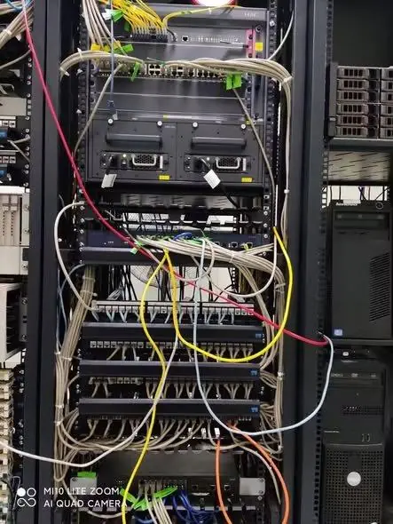 Server room before reorganization with tangled cabling